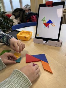 kinderhände beim legen von mustern nach einer interaktiven tablet-vorlage